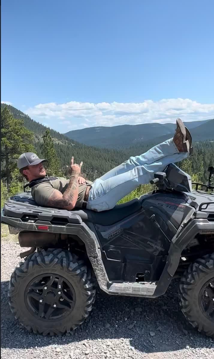 Trevor throwing rock-on sign on ATV