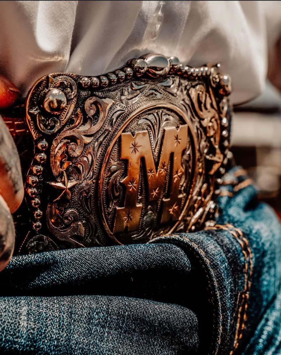 Ornate western belt buckle with M initial